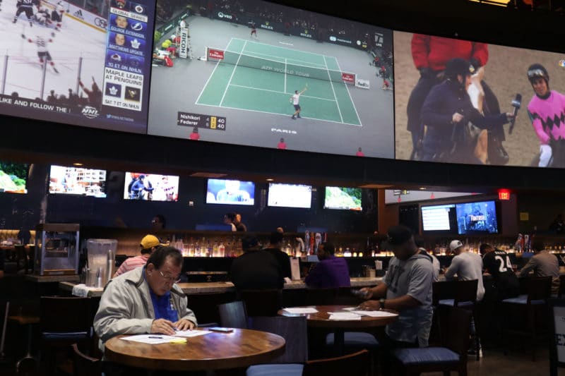 East Rutherford, NJ 11/2/2018 NJ SPORTS BETTING: A gentleman contemplates his next bet to place by going over the money lines and spreads.