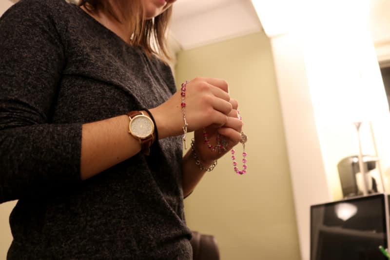 CLIFTON, NJ 10/30/18 SOPHIE OUELLETTE PRAYS THE ROSARY: Newman Catholic Campus Ministry Missionary Sophie Ouellette prays her evening Rosary before changing into her Halloween costume. Participating in the annual Newman Catholic Halloween party is one of her favorite traditions.
-Photo by Katherine Braunstein